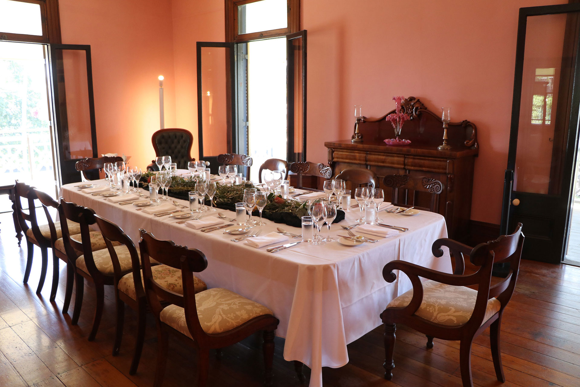 Newstead House Dining Room set with a table in white linen and vintage upholstered chairs