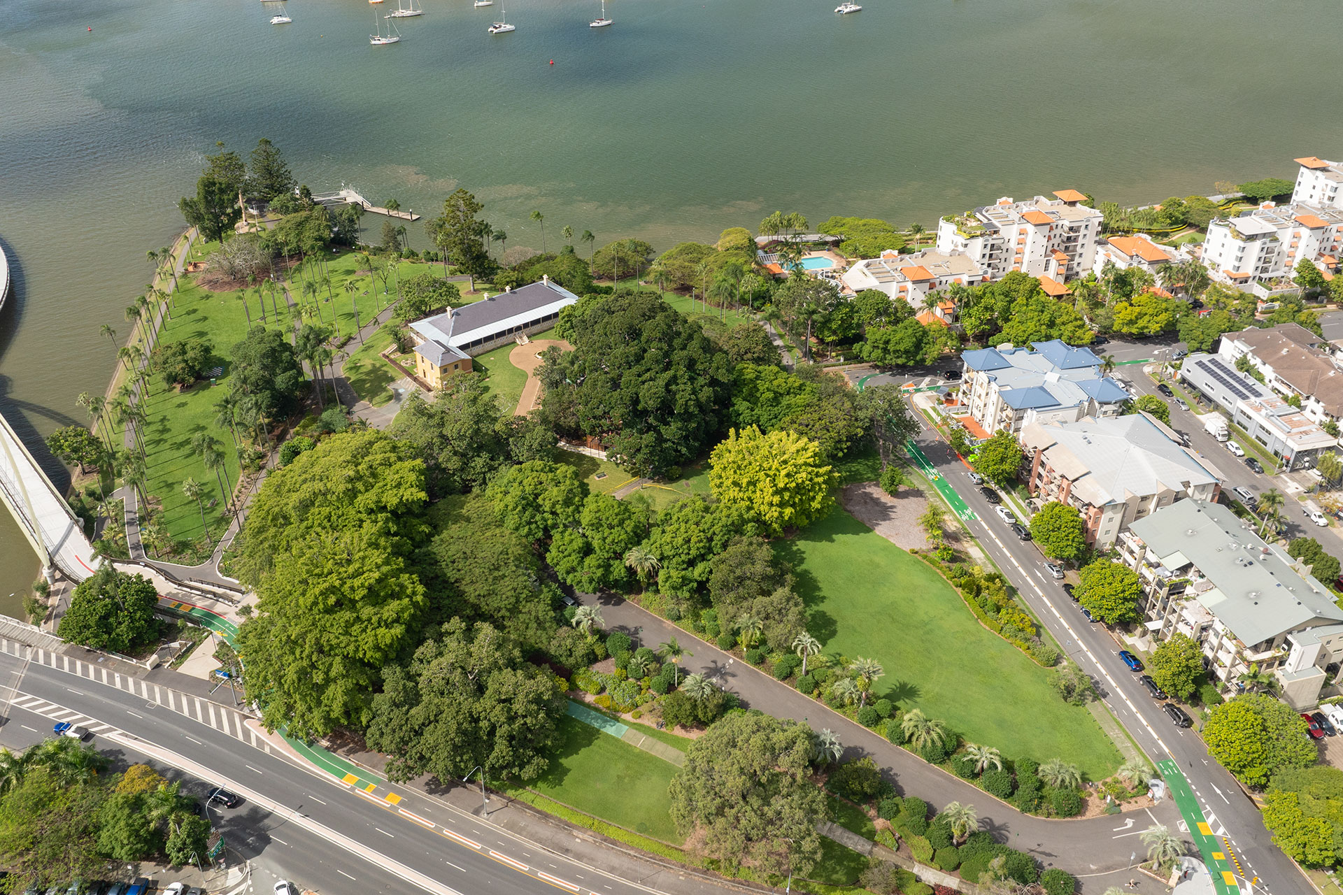 Aerial view over Newstead House and Park with lush greenery and roads and Brisbane River surrounding