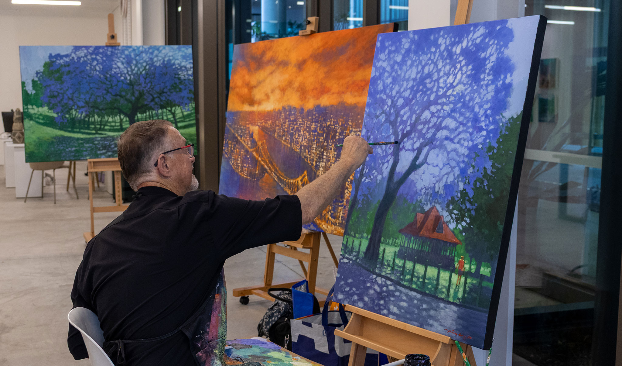 David Hinchcliffe painting a mature jacaranda tree