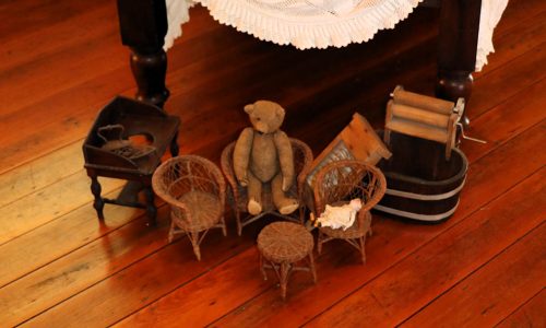 Various childres toys incluing a teddy bear small table and chairs and small victorian era washing equipment