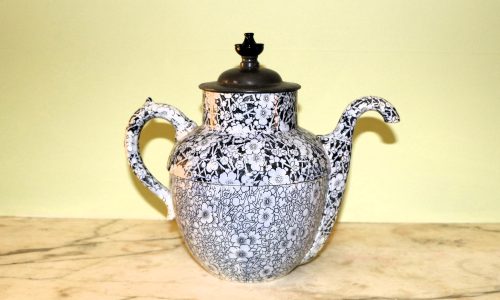 White china teapot with blue floral pattern and metal lid